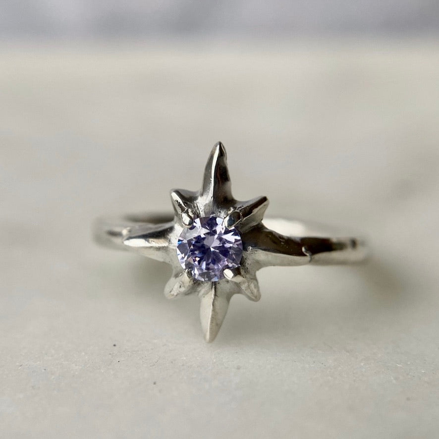 Close up of Silver polaris north star ring set with faceted lavender Cubic Zirconia, handmade by Iron Oxide Designs