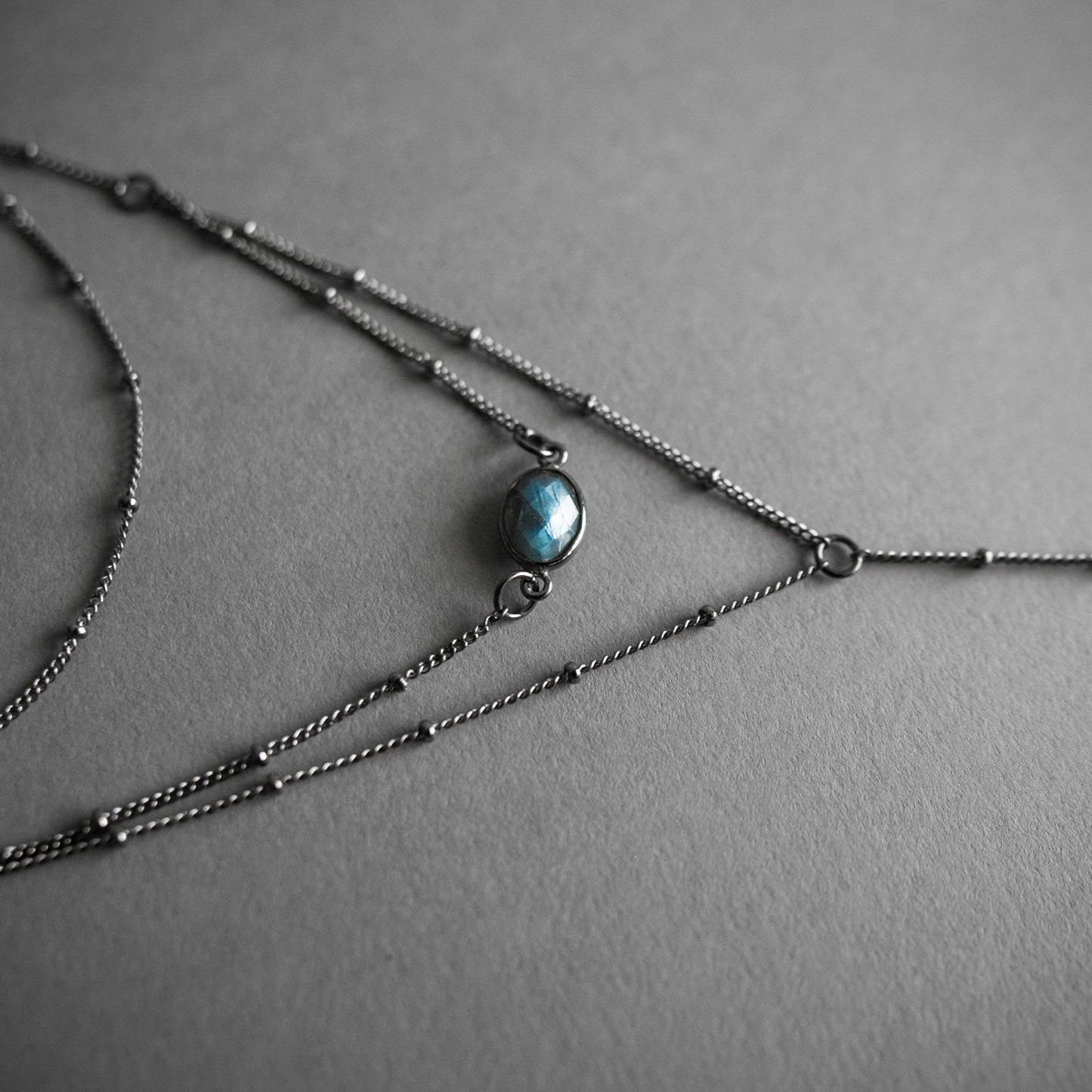 Layered Labradorite Lariat Necklace with crystal drop set on a dotted gunmetal chain