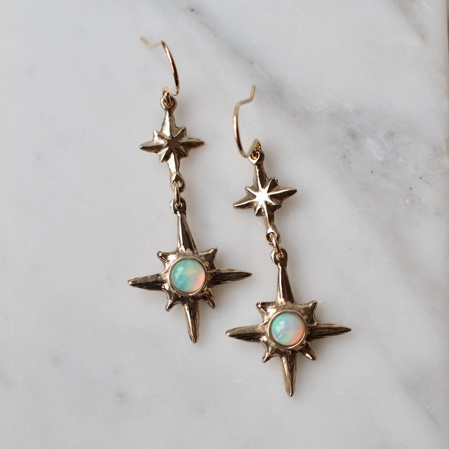 North Star Dangle earrings set with sustainably sourced natural opal, artisan made jewelry by Iron Oxide Designs.