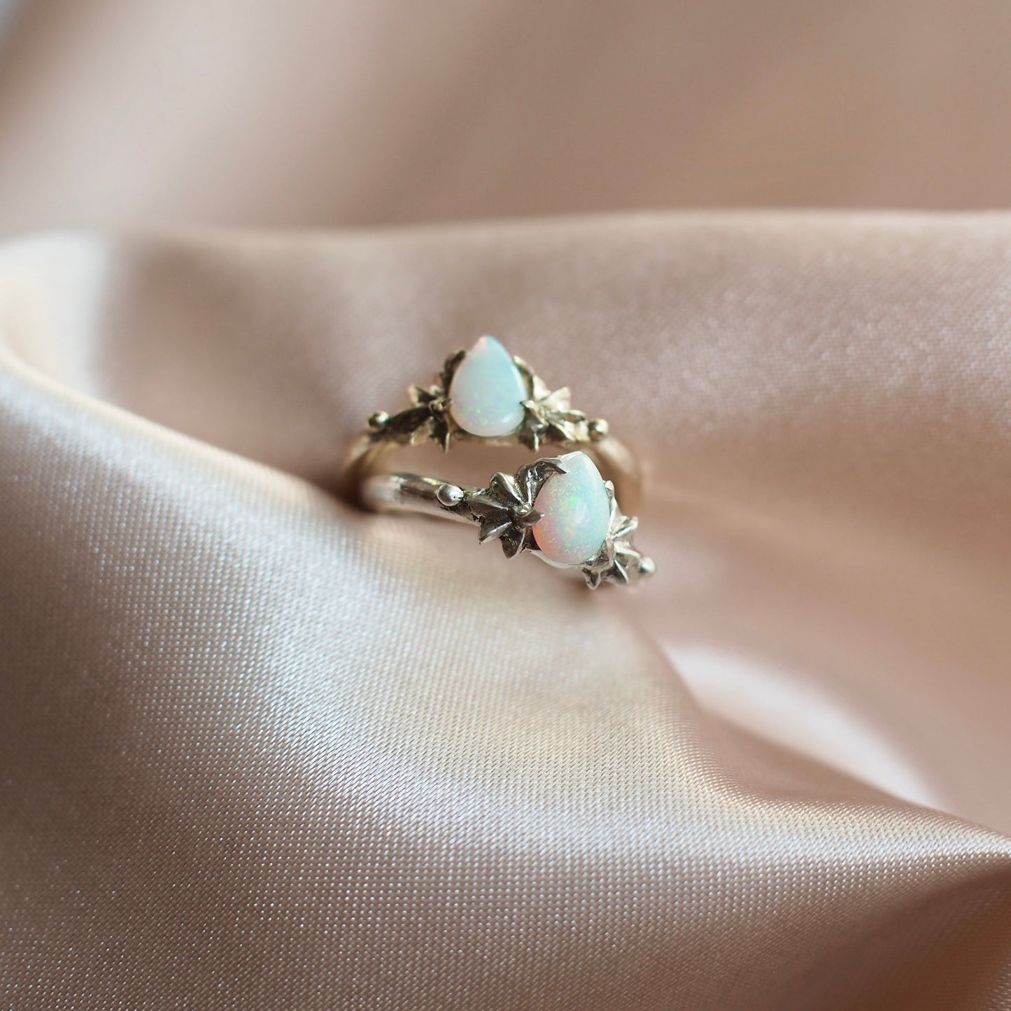 Teardrop shaped lab grown opal set between two star setting in sterling silver or gold tone bronze by Iron Oxide Designs