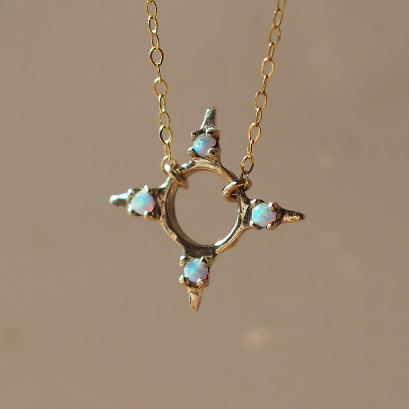 Four point star shaped Opal Eclipse Necklace by Iron Oxide designs made with 2mm lab grown opals set in bronze. 