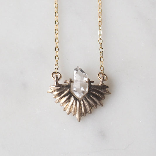 Bronze celestial and clear quartz crystal necklace on a gold chain by Iron Oxide Designs