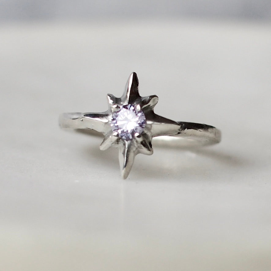 Silver polaris north star ring set with faceted lavender Cubic Zirconia, handmade by Iron Oxide Designs