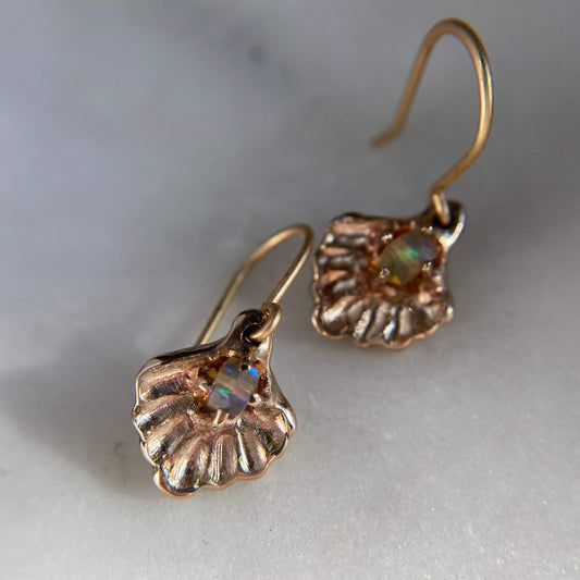 Oyster shell earrings containing a small opal "pearl", cast in gold tone bronze by Iron Oxide Designs