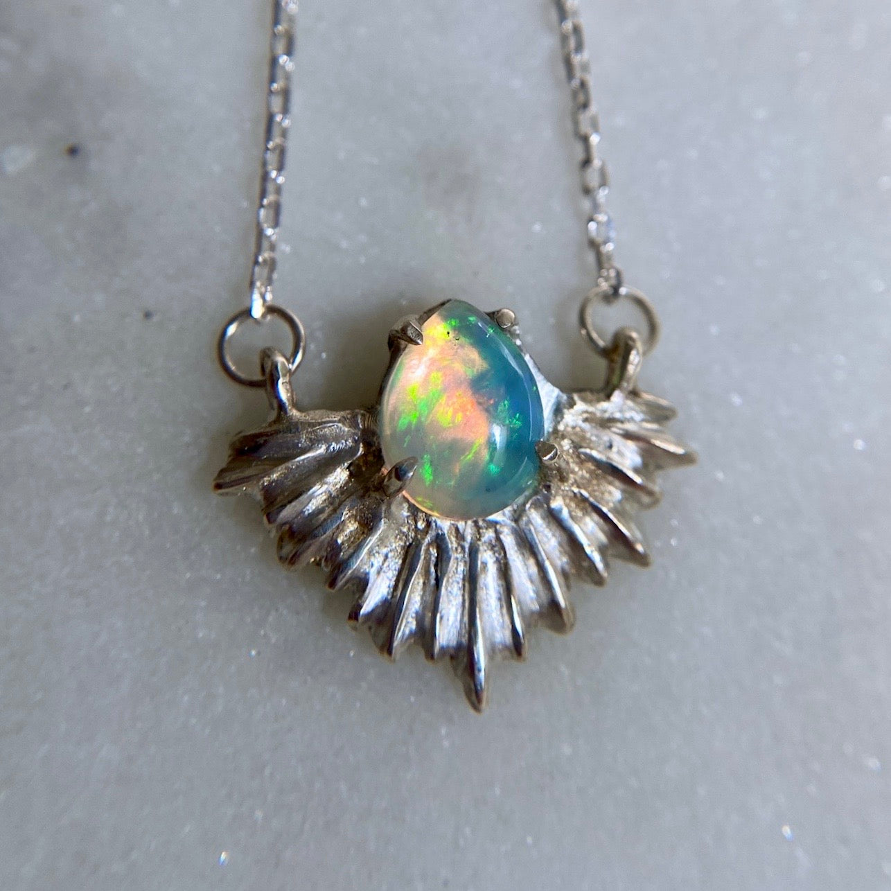 Cosmic opal necklace set in a sterling silver setting, handmade in the USA by Iron Oxide