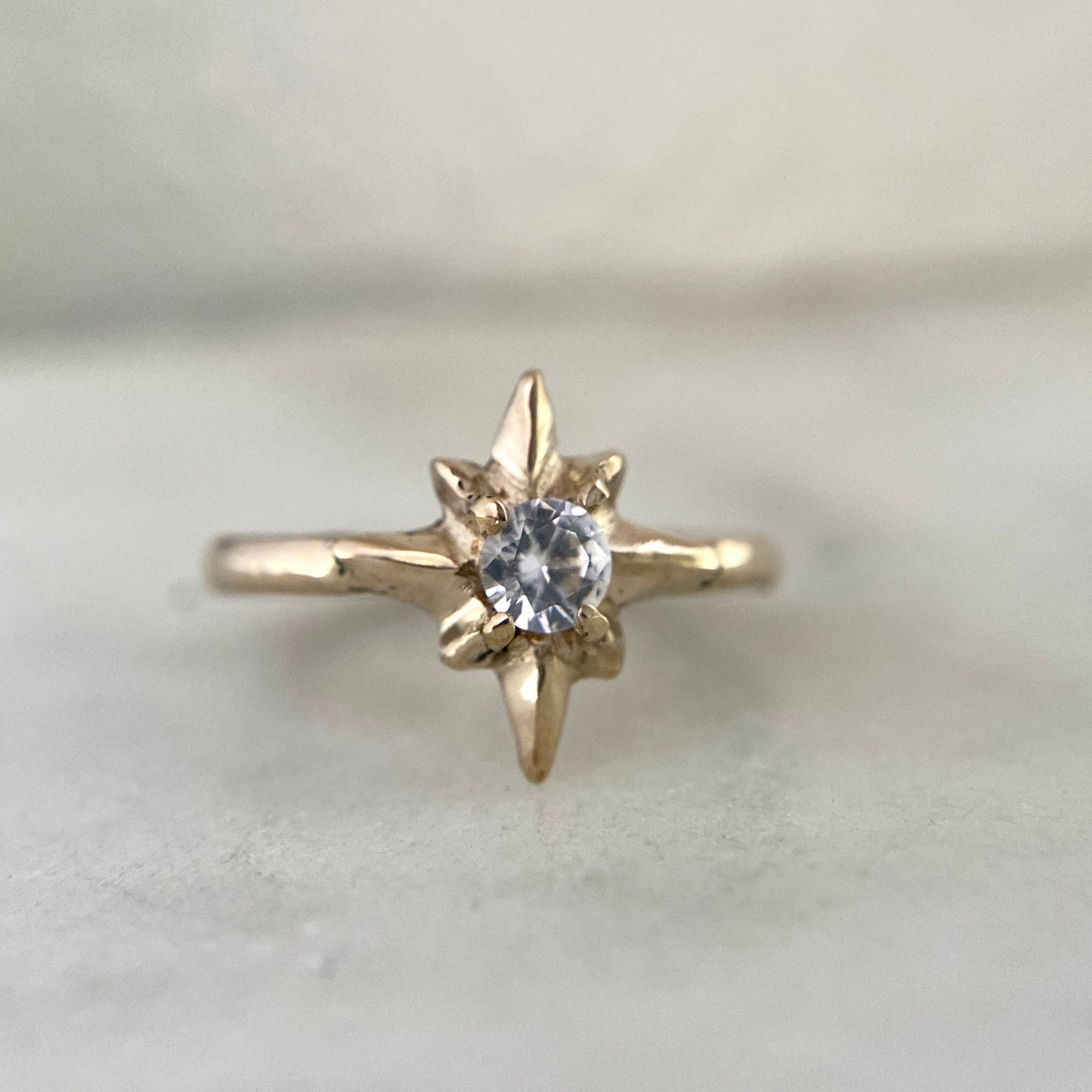 Polaris North Star Ring cast in gold tone bronze set with a clear Cubic Zirconia, by Iron Oxide Designs