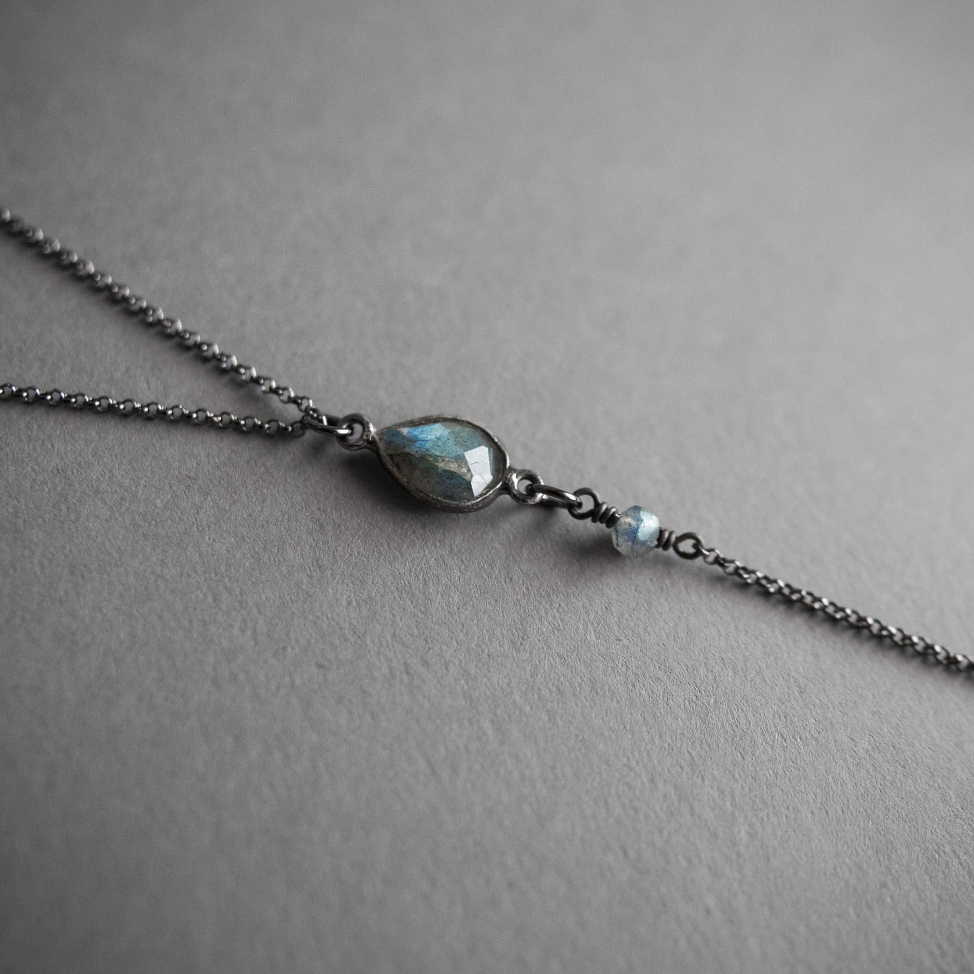 Labradorite lariat y necklace with crystal drop , close up on the labradorite teardrop piece