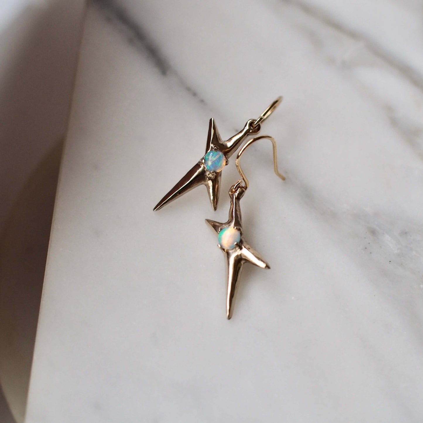Spikey electric spark earrings set with sustainably sourced opal in gold tone