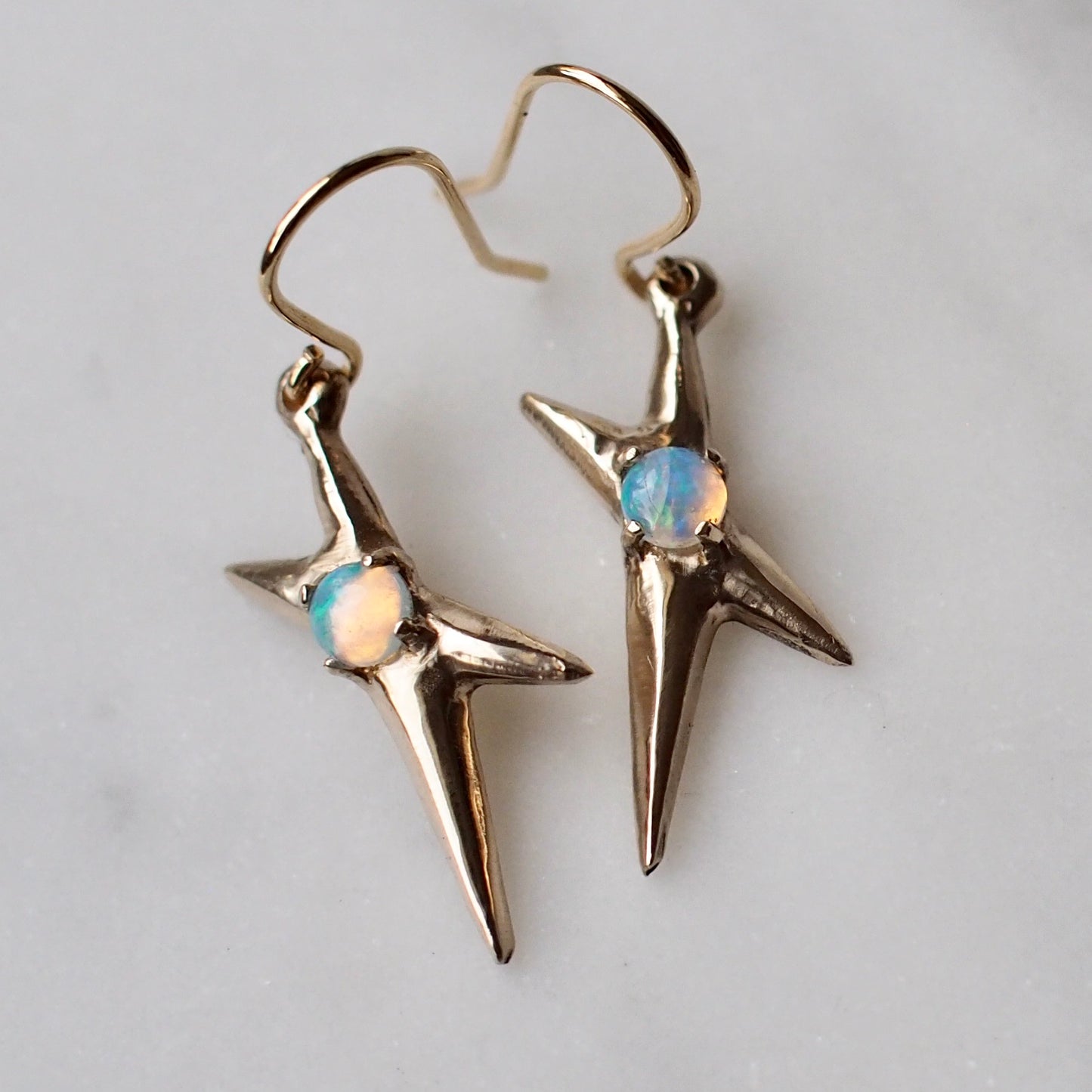 Spikey electric spark earrings set with sustainably sourced opal in gold tone