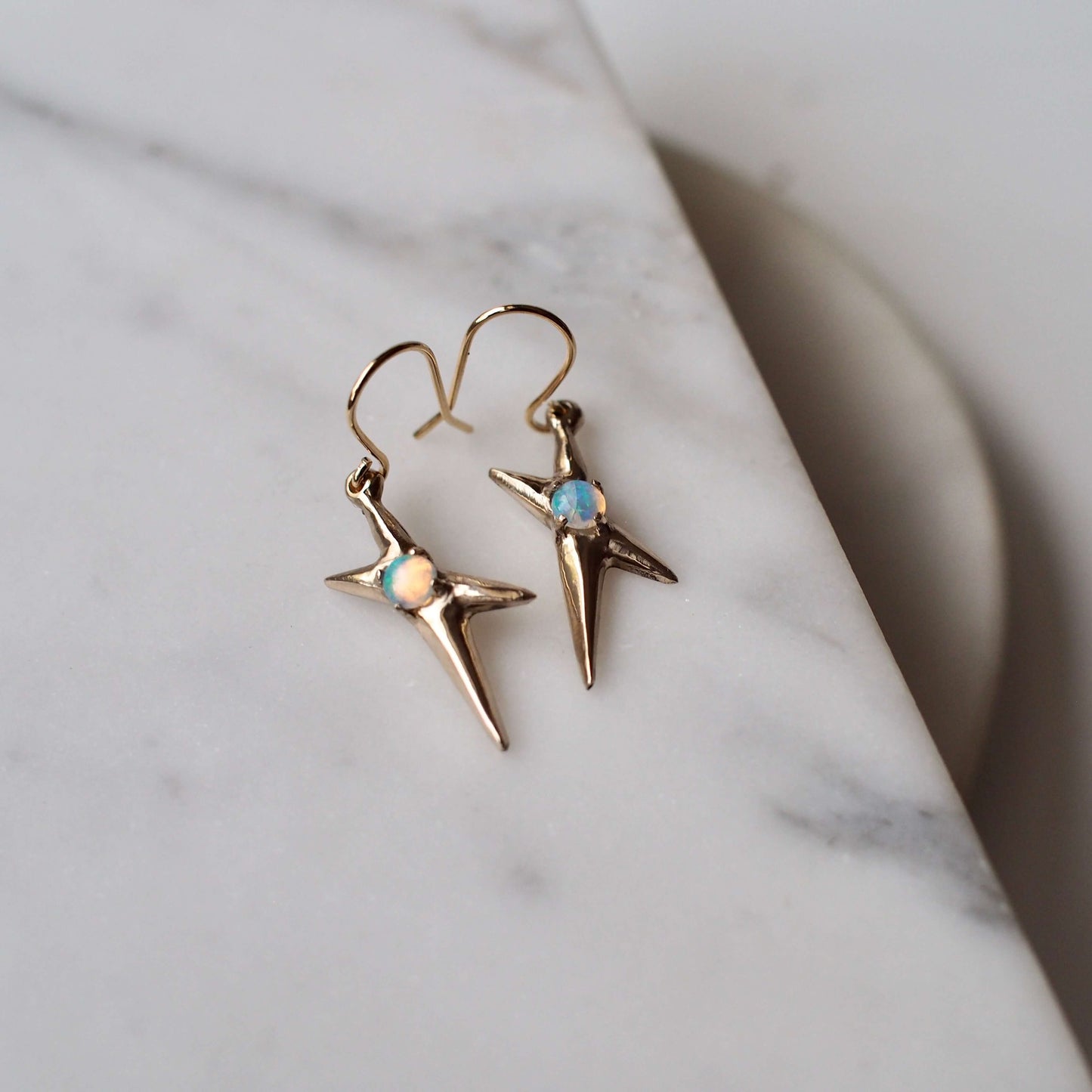 Spikey electricity earrings set with sustainably sourced opal in gold tone