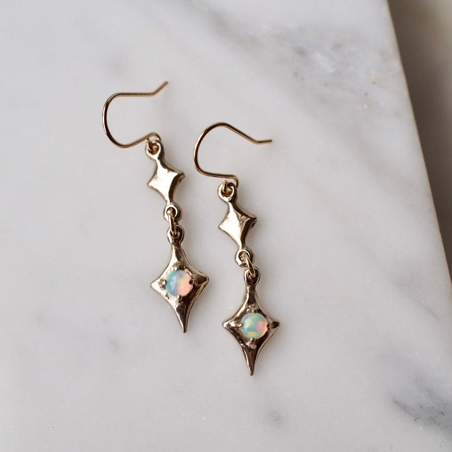 Sparkle emoji earrings featuring natural opals
