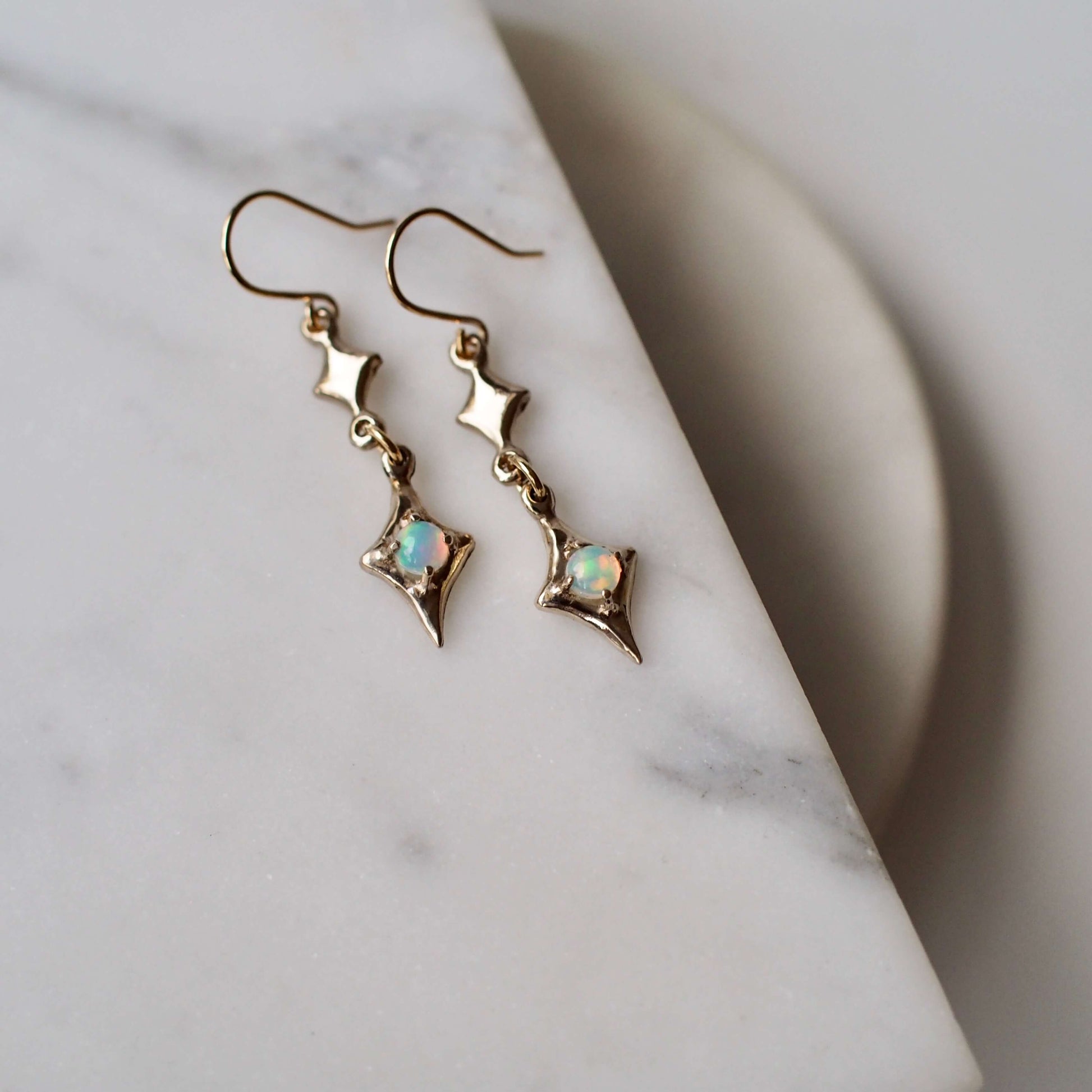 Sparkly four point star earrings featuring natural opal