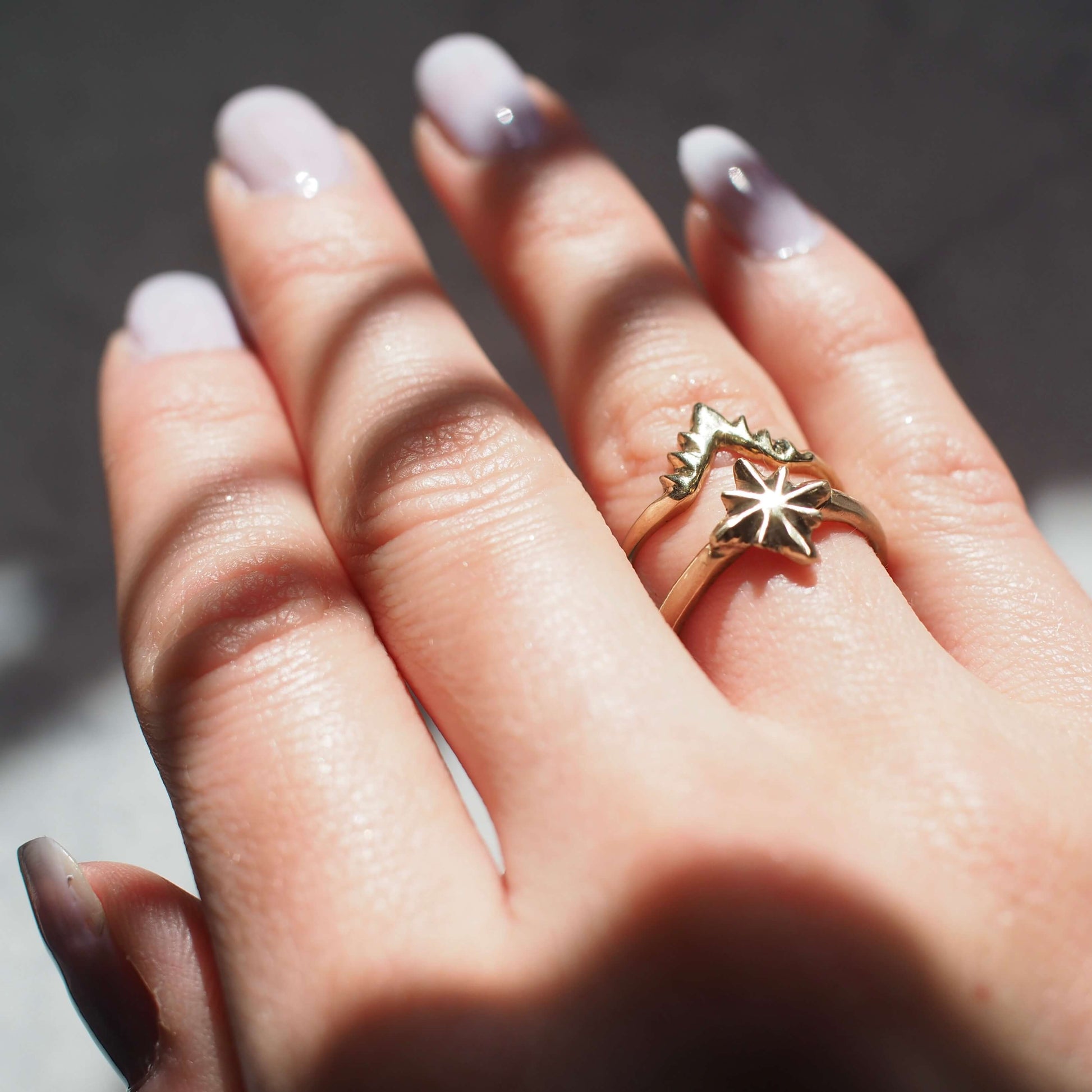 Celestial North Star Stacking ring set in Gold Tone Bronze shown on a model's hand