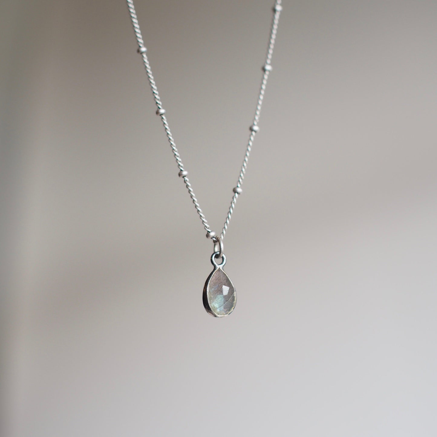 Mini labradorite teardrop choker set on a dusty silver gunmetal choker