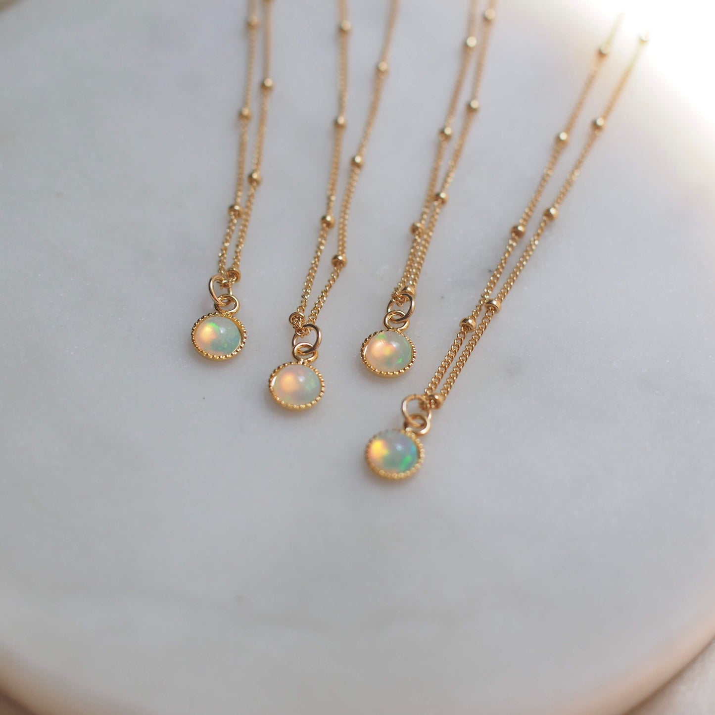 Dainty opal chokers on a dotted gold fill chain. 