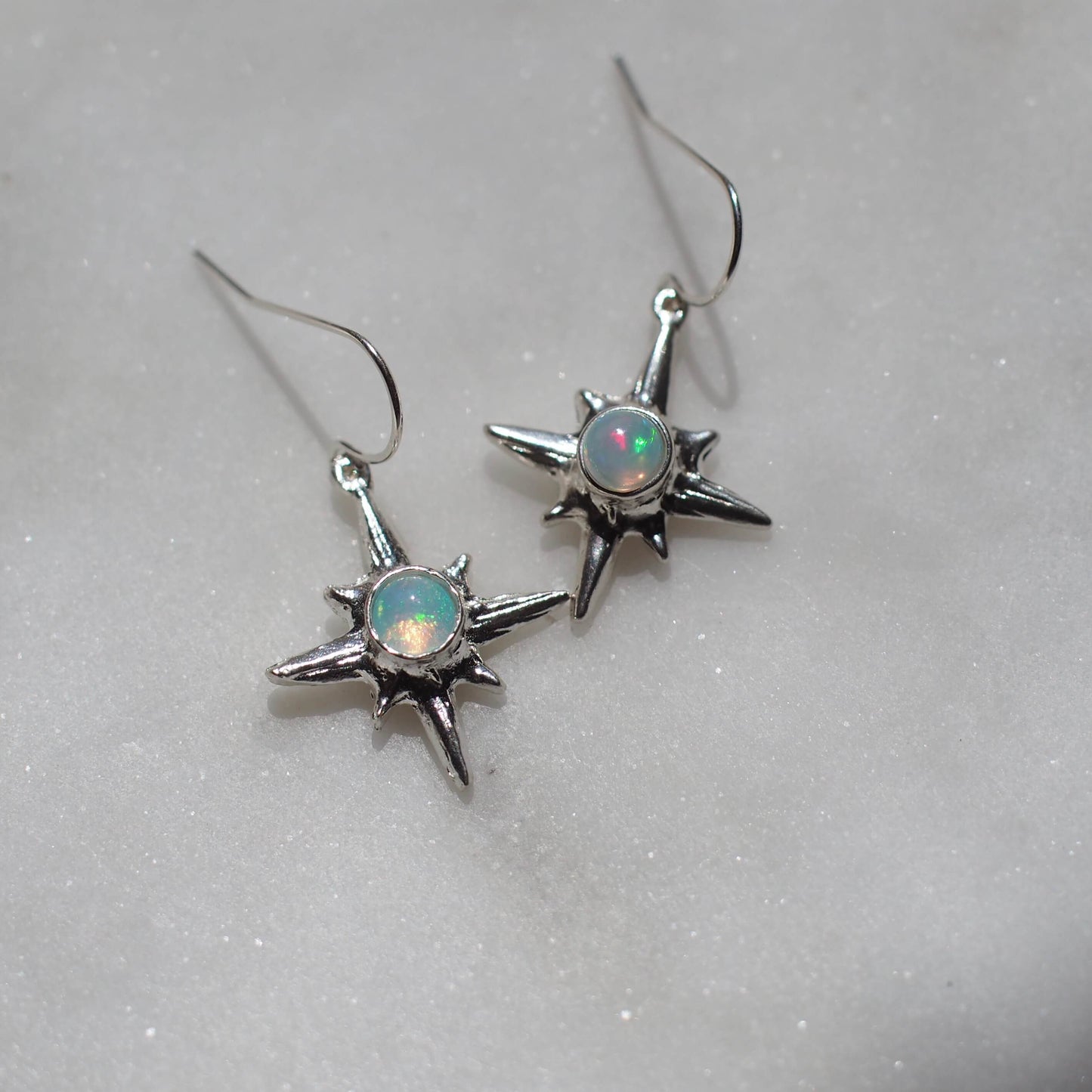 North Star earrings set with sustainably sourced opal artisan made jewelry by Iron Oxide Designs