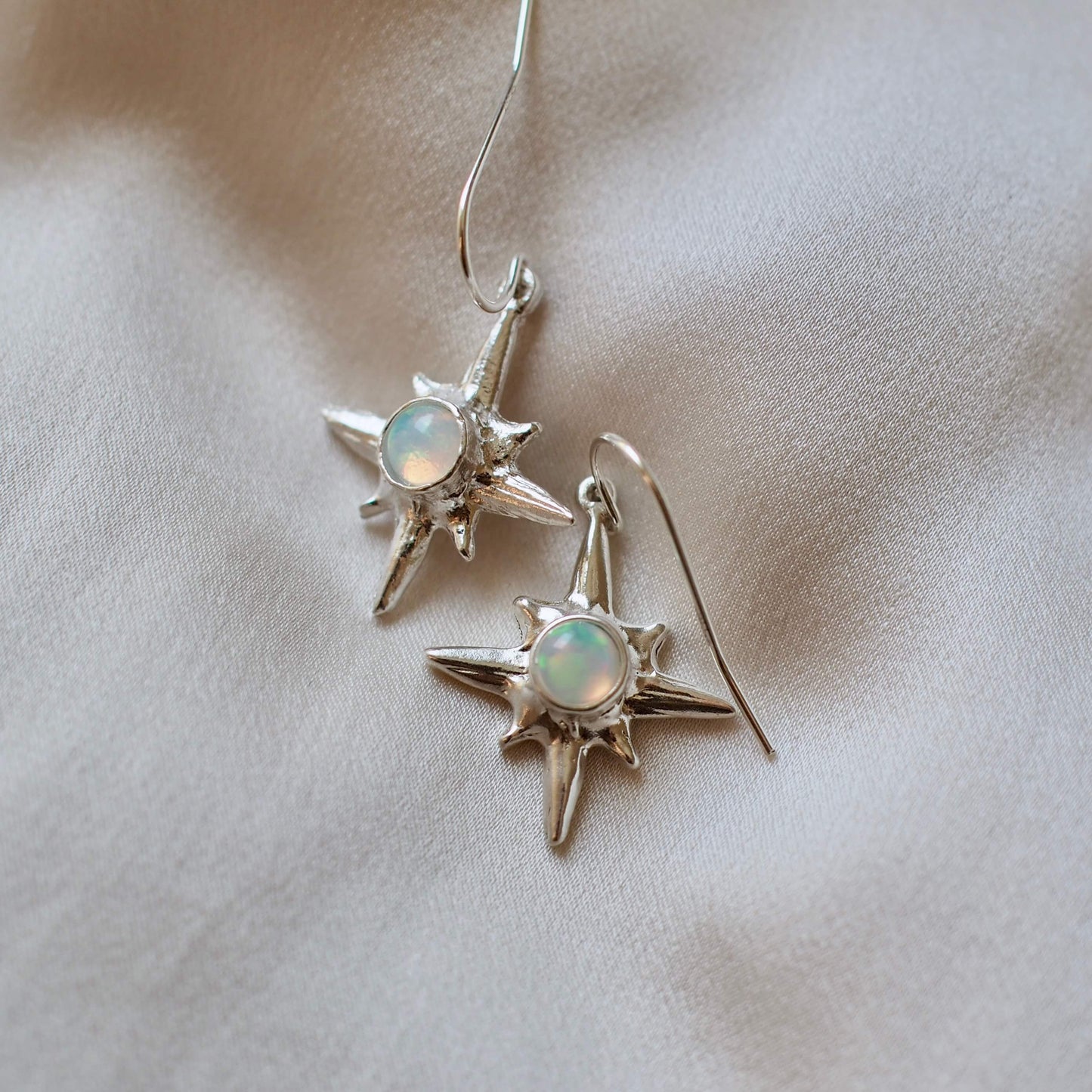 North Star earrings set with sustainably sourced opal artisan made jewelry by Iron Oxide Designs