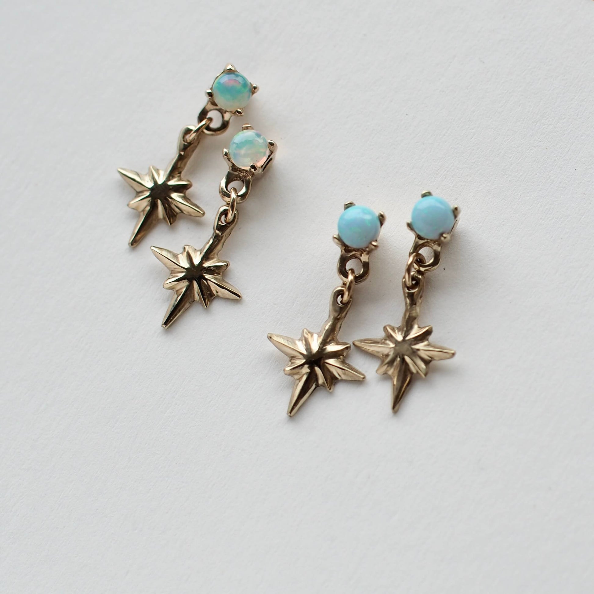 Tiny star dangle earrings in gold tone bronze and sterling silver, set with natural and synthetic opals