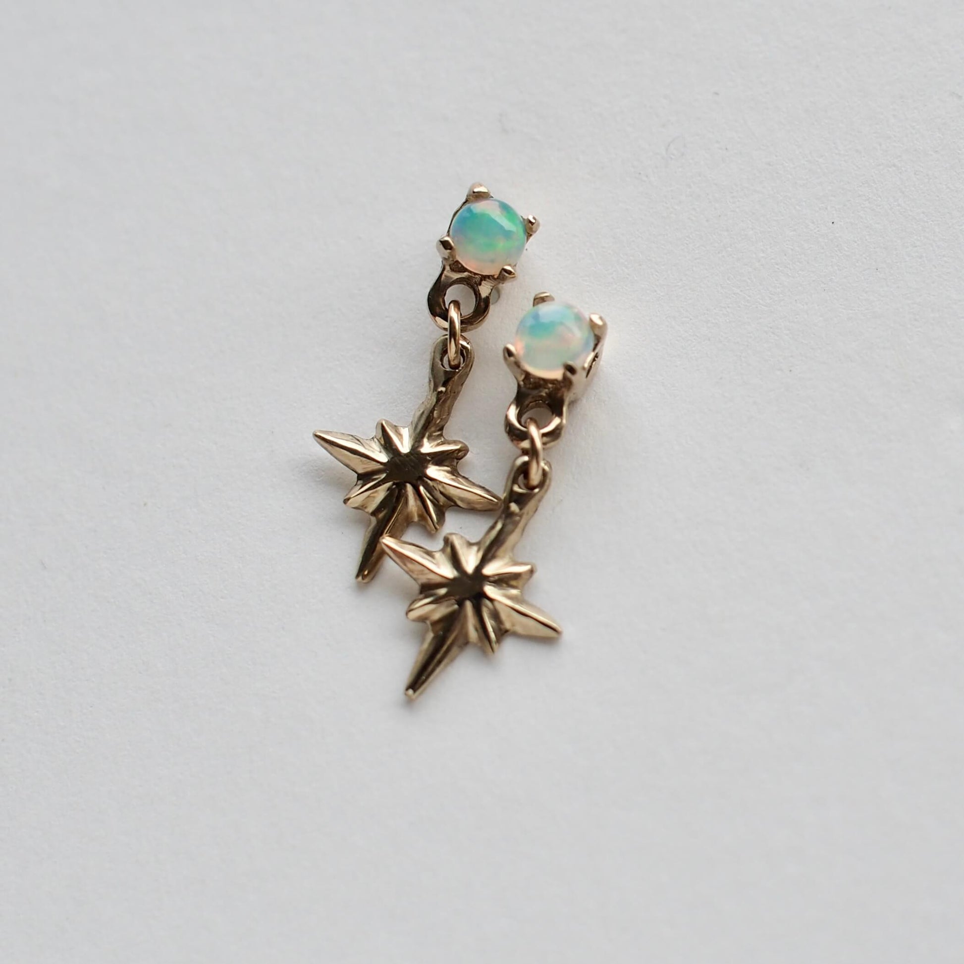 Tiny celestial earrings in gold tone bronze, set with opals