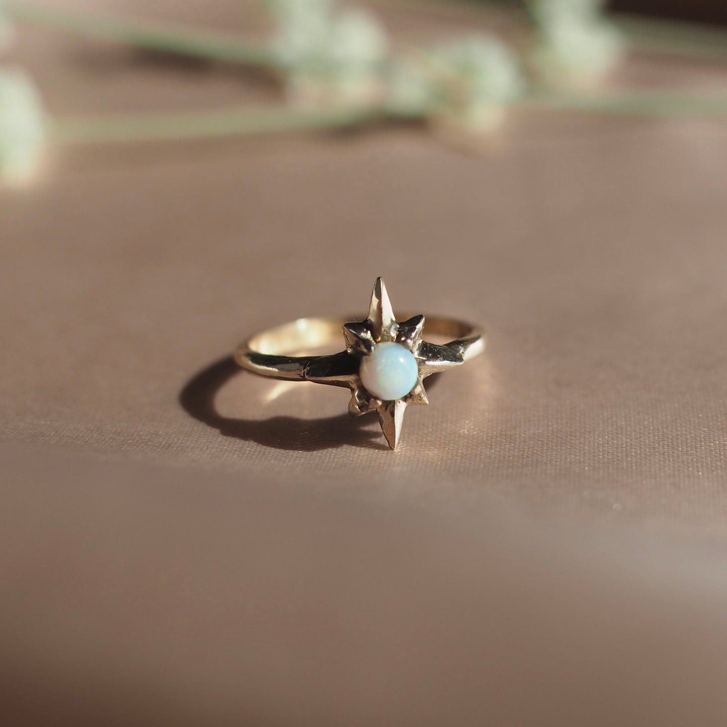 Polaris North Star Ring cast in gold tone bronze set with lab grown opal, by Iron Oxide Designs