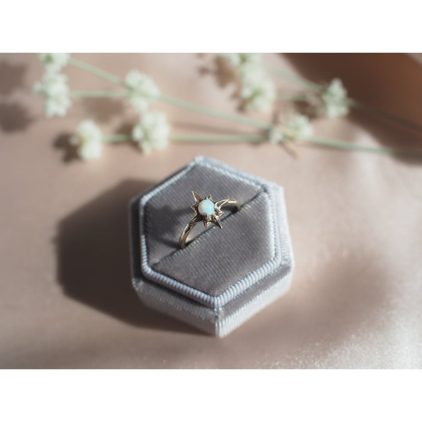 Polaris north star ring set with a tiny lab grown opal in sterling silver handmade by Iron Oxide Designs in a velvet ring box 
