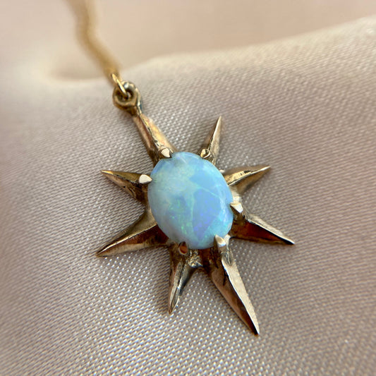 Close up of Supernova large star necklace set with lab grown opal by Iron Oxide Designs