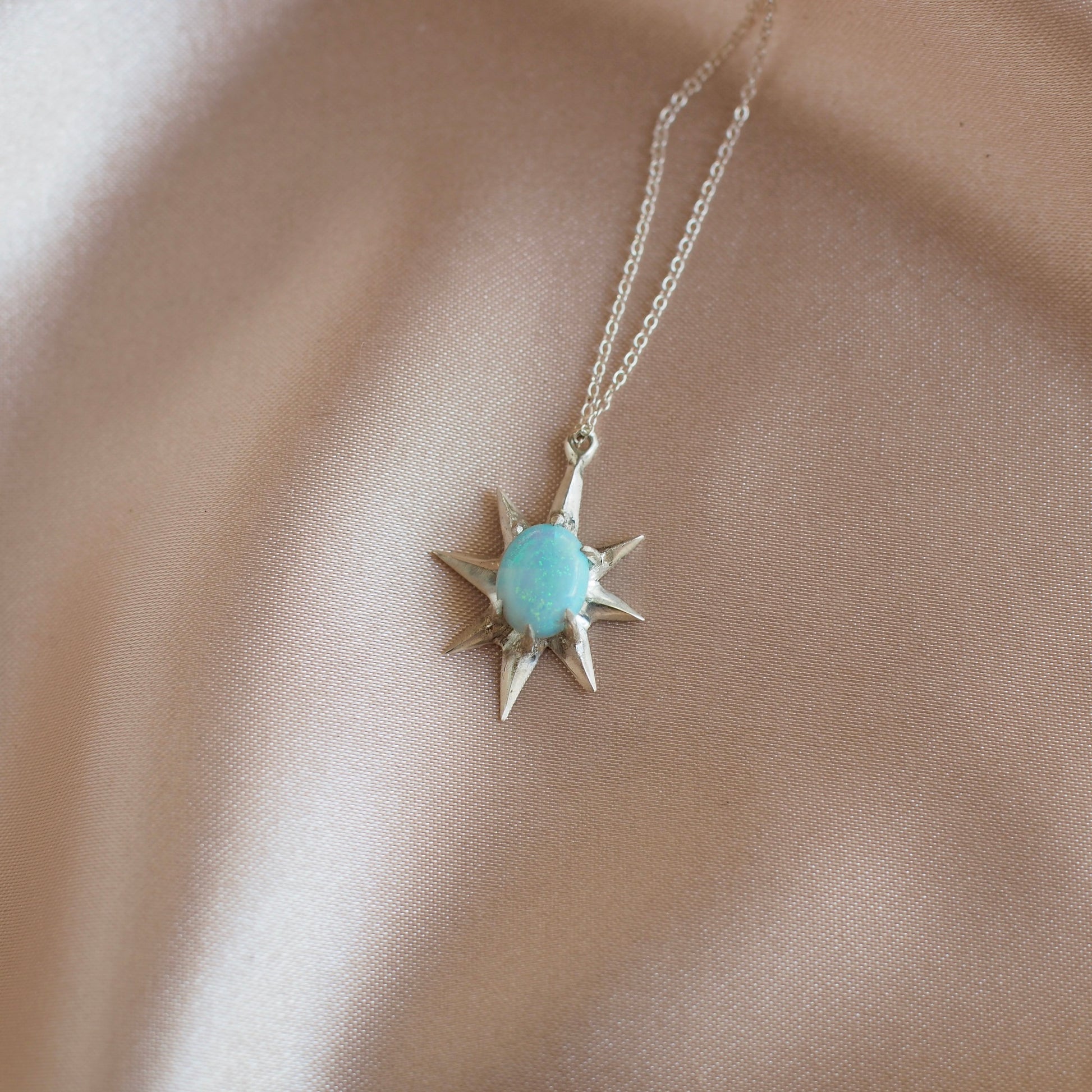 Close up of Supernova large star necklace set with lab grown opal in sterling silver